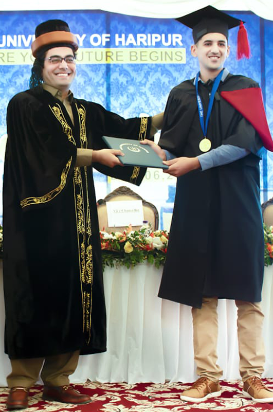 Omer khan jadoon recieving Gold medal from education minister of kpk